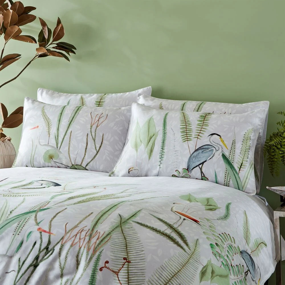 Aaliyah botanical heron print pillowcase pair styled on bed, multi – Paoletti