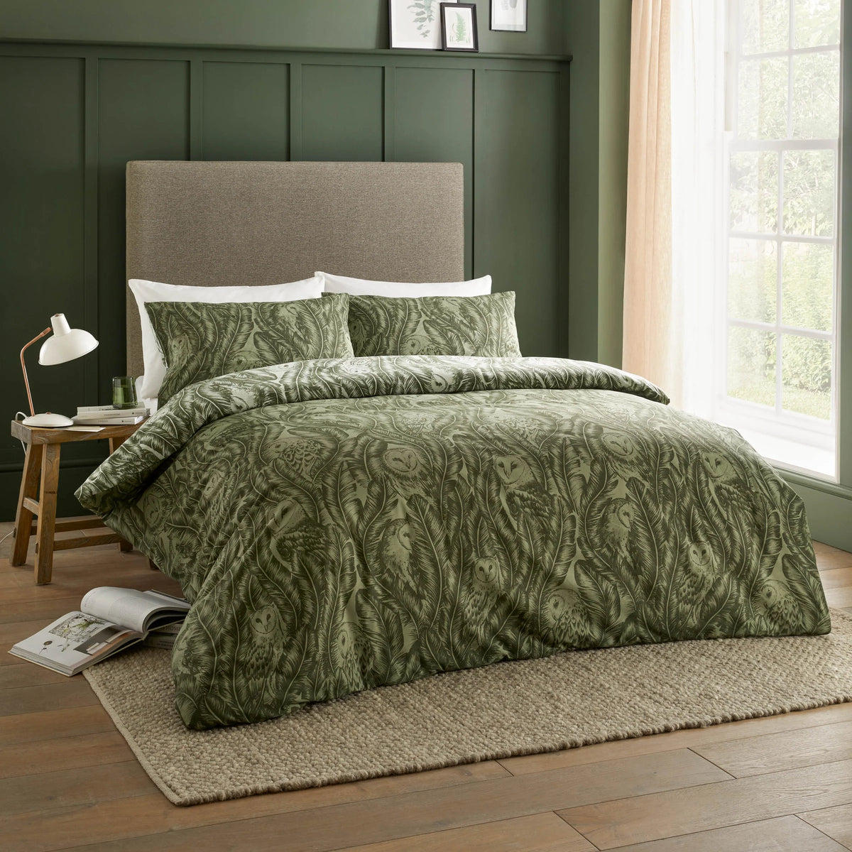 Full bed dressed in the forest green owl print duvet cover set with matching pillowcases, showing the repeat barn owl and banana leaf design across the entire duvet – Kumperi