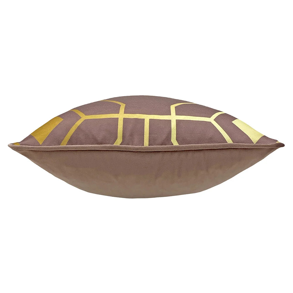 Side profile of the plump cushion showing the gold geometric printed front meeting the plain blush velvet reverse along a piped seam – Kumperi