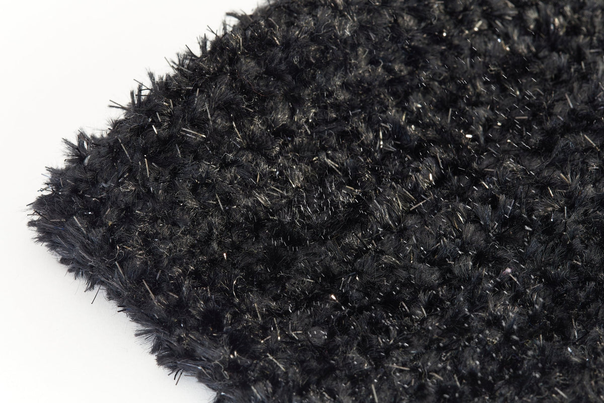Extreme close-up of black Twinkle shaggy bath mat showing soft fluffy pile with fine silver metallic twinkle threads catching the light Emma Barclay Lifestyle Collection