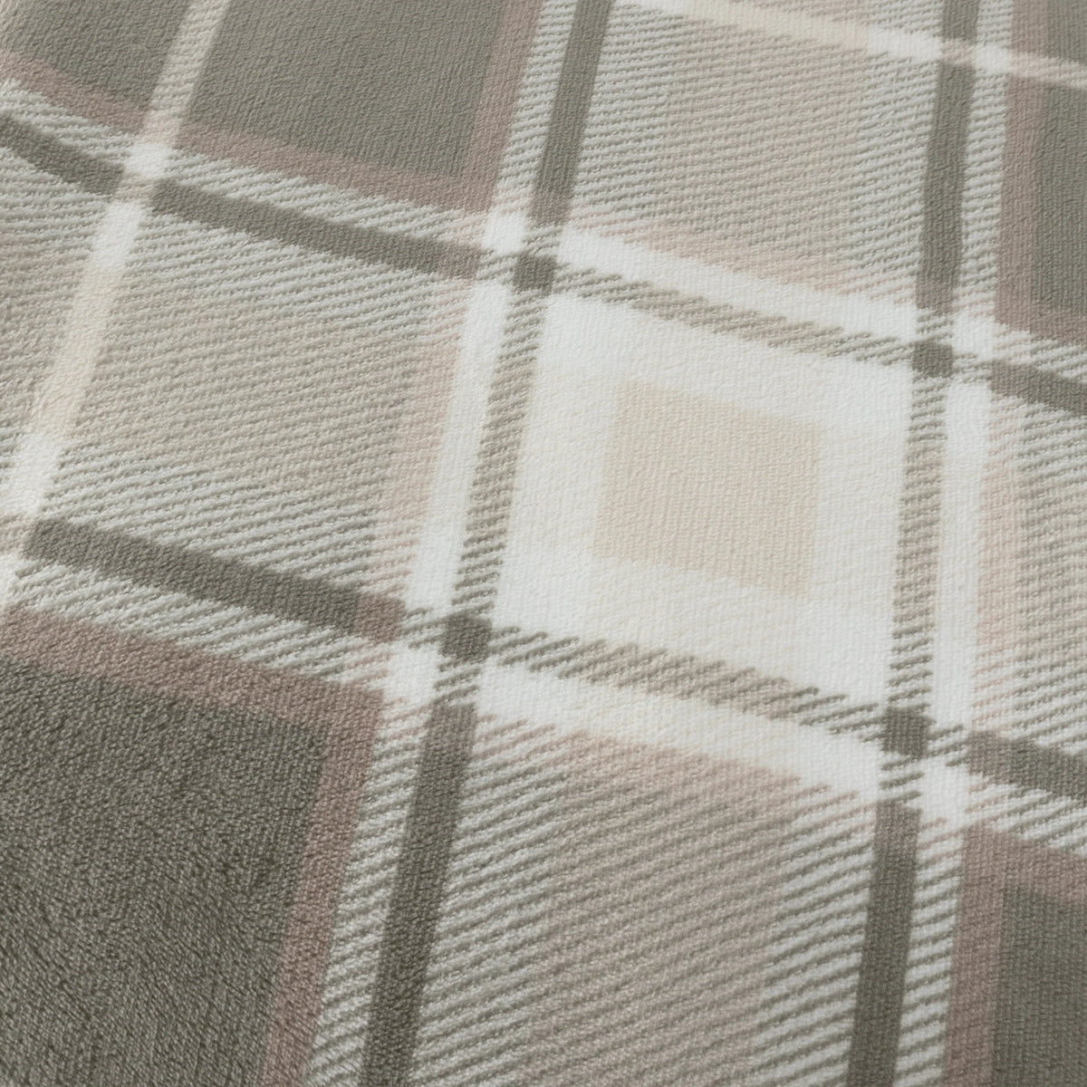 Close-up detail of the tartan check print showing green and taupe squares bordered in dark grey, with cream and pink stripe lines crossing through the fabric weave – Kumperi