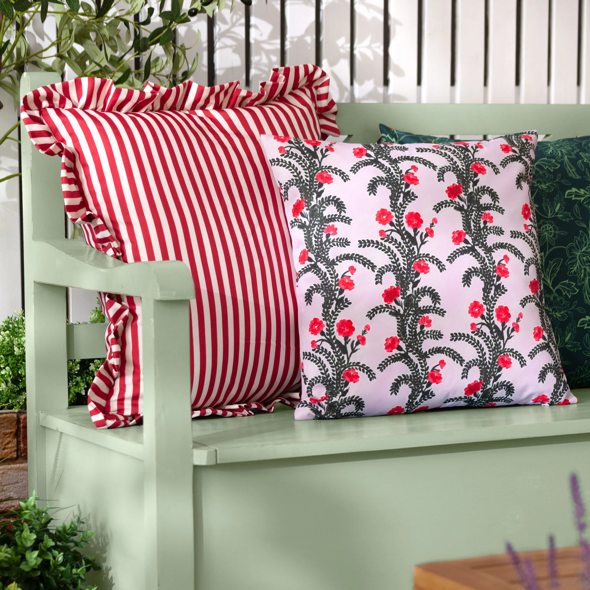 Lilac floral outdoor cushion styled on a garden bench alongside striped cushion – Kumperi