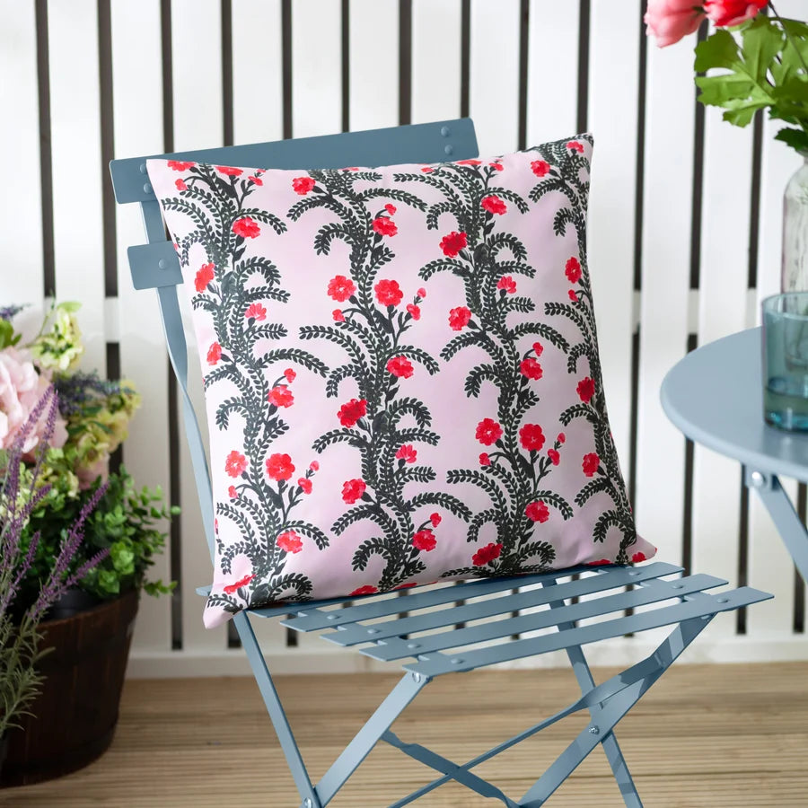 Lilac floral reversible outdoor cushion styled on a garden chair – Kumperi