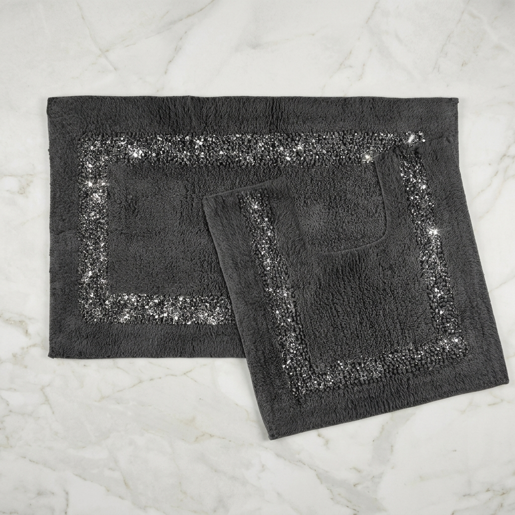 Charcoal Brillare cotton bath mat and pedestal mat overlapping on a white marble background showing loop and bobble pile with silver sparkle border trim Emma Barclay Panache Home