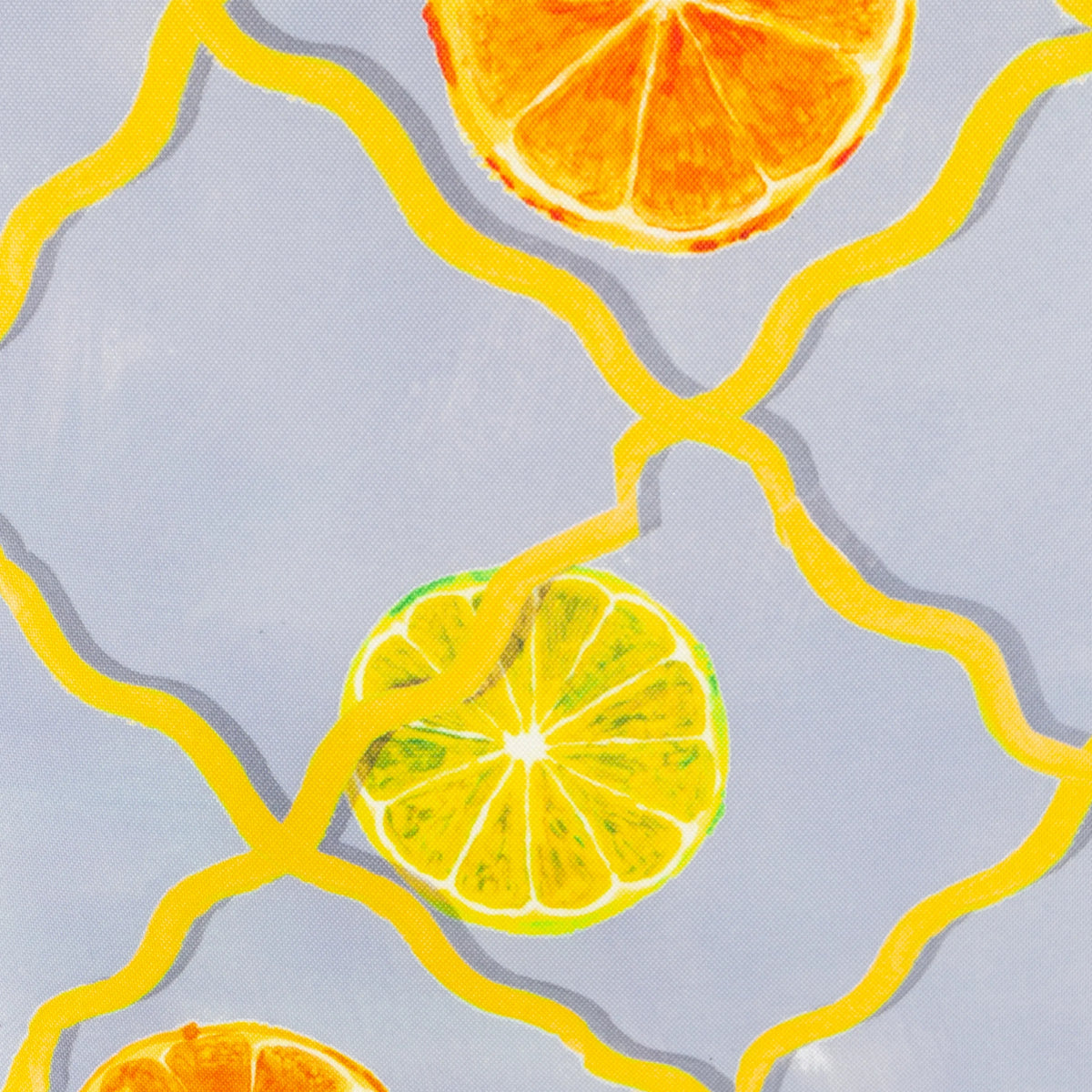 Close-up detail of the print showing a hand-painted orange slice and lemon slice on the yellow trellis lattice over a pale blue background – Kumperi