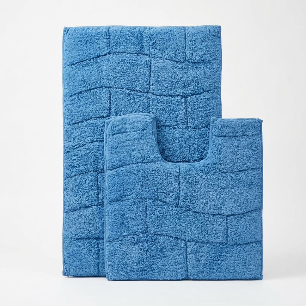 Cobalt blue 100% cotton wave block texture bath mat and pedestal mat stood upright against white background showing pedestal toilet cut-out shape clearly and thick deep raised block pile texture 2-piece set Emma Barclay Waves design