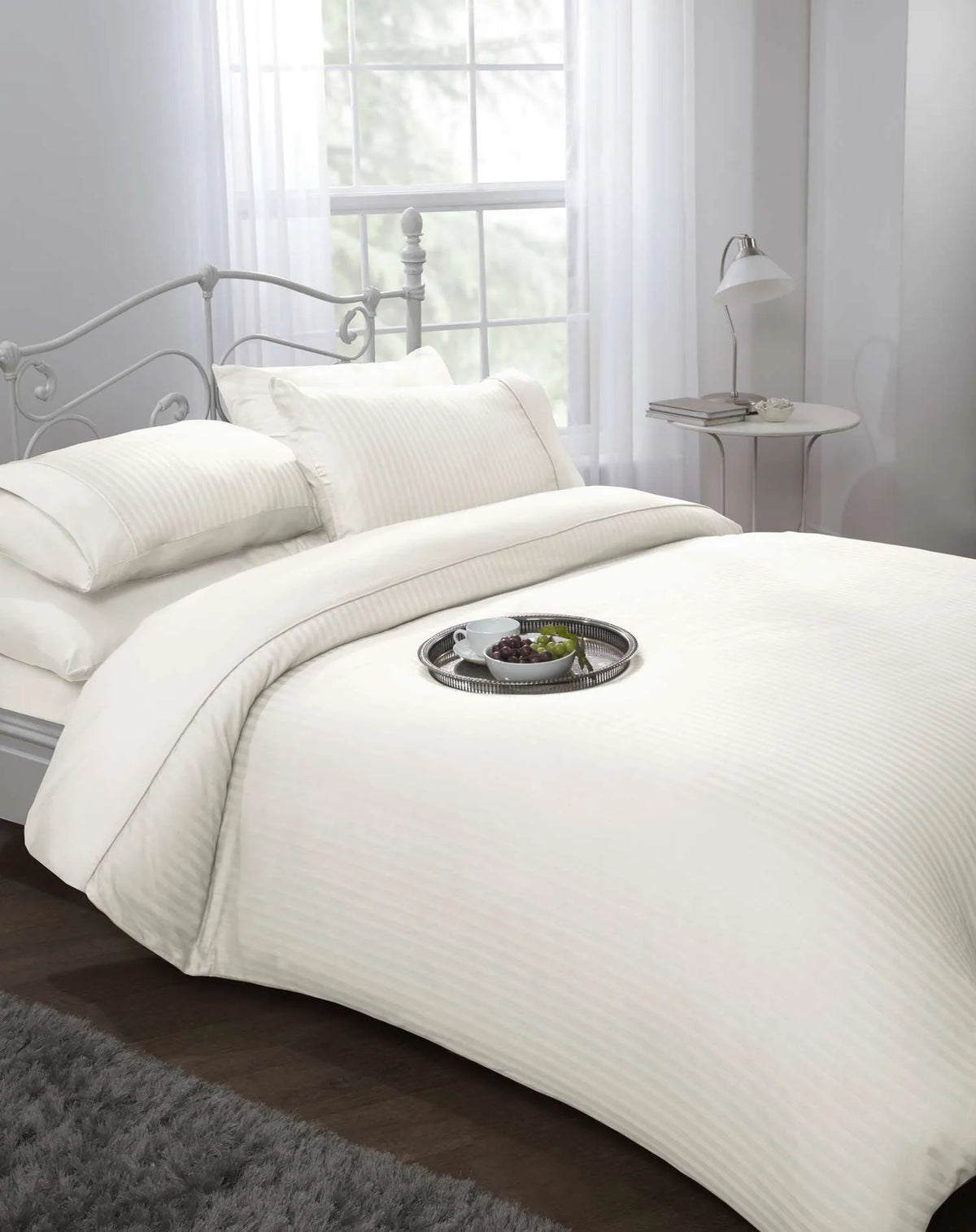 Cream 300 thread count sateen stripe king duvet cover set styled on a luxury hotel style bed