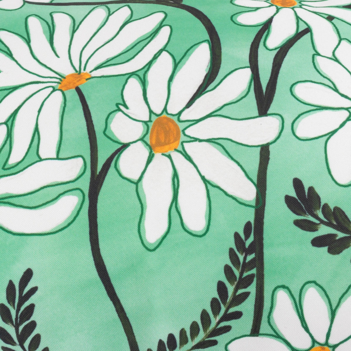 Close-up detail of the hand-drawn daisy print showing large white petals with orange centres, dark stems and fern leaf fronds on a mint green ground – Kumperi