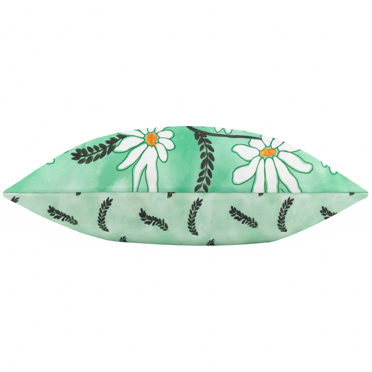 Side-on profile view of the cushion showing the white daisy print on one side and the fern-leaf print on the reverse, meeting at a plain seam – Kumperi