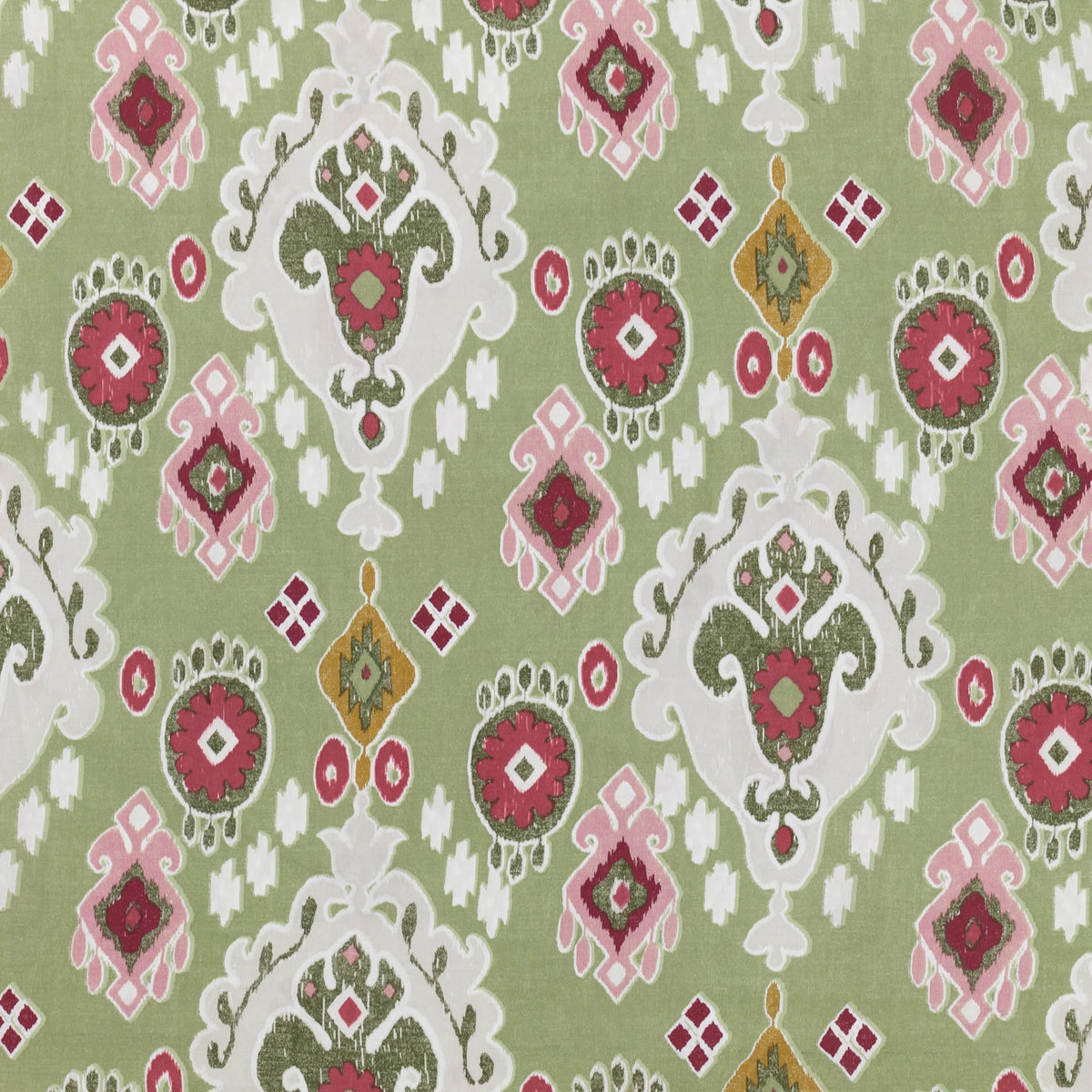 Flat close-up of the cedar green Ikat print fabric showing pink, red and mustard medallion motifs with scrolling cream foliate scallops and diamond accents – Kumperi