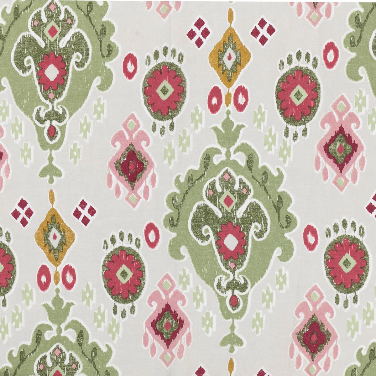 Flat close-up of the reverse cream side of the Ikat print showing the same green, pink and mustard medallion and diamond motifs on a pale ground – Kumperi