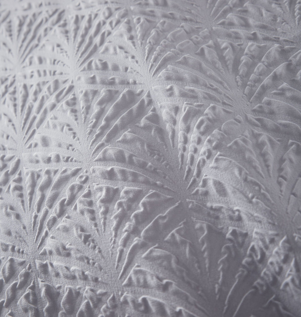Close-up of grey embossed geometric texture on soft-touch king duvet cover