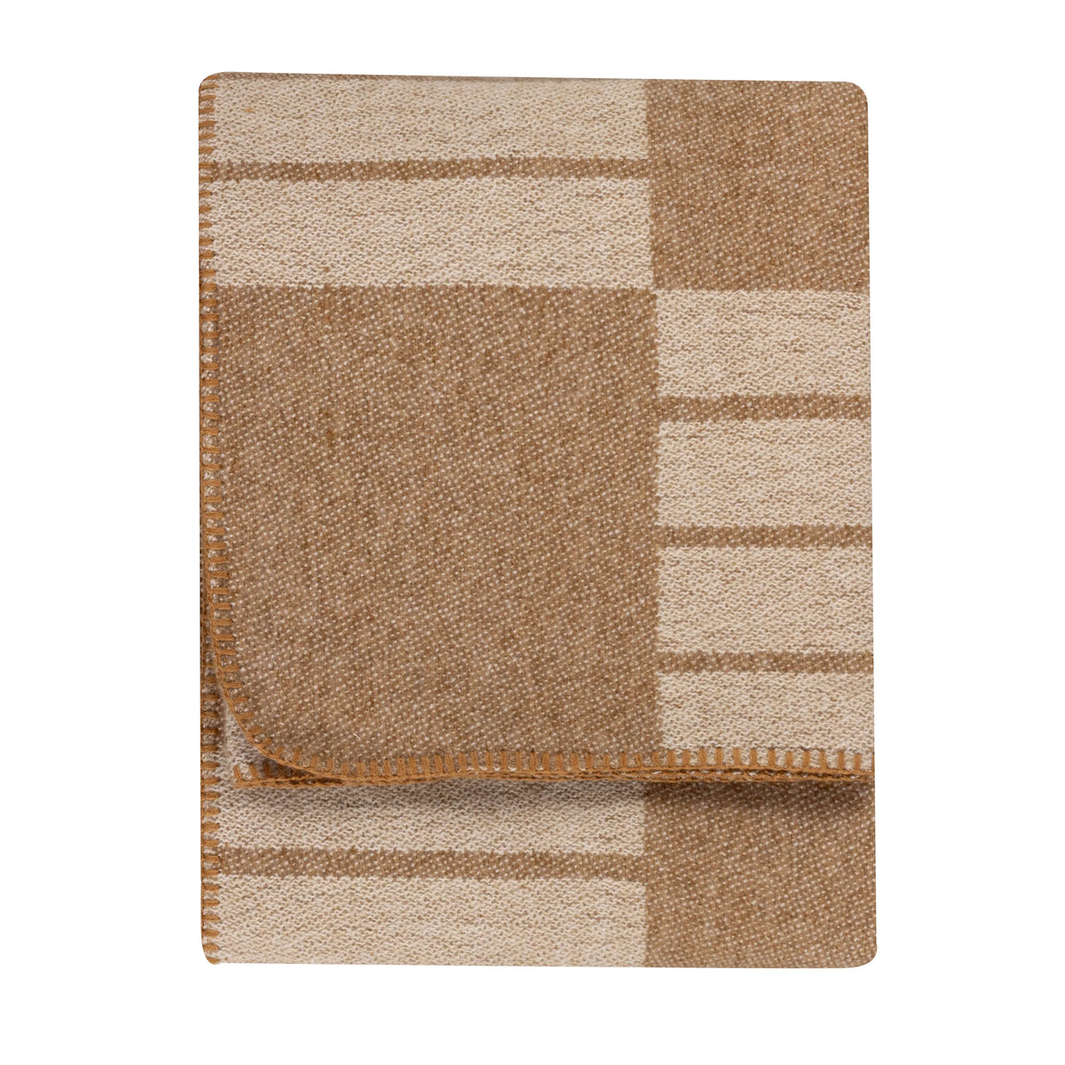 Folded biscuit and cream woven throw showing a geometric block and stripe pattern, with one corner turned back to reveal the reverse side, edged with a tan blanket stitch trim – Kumperi
