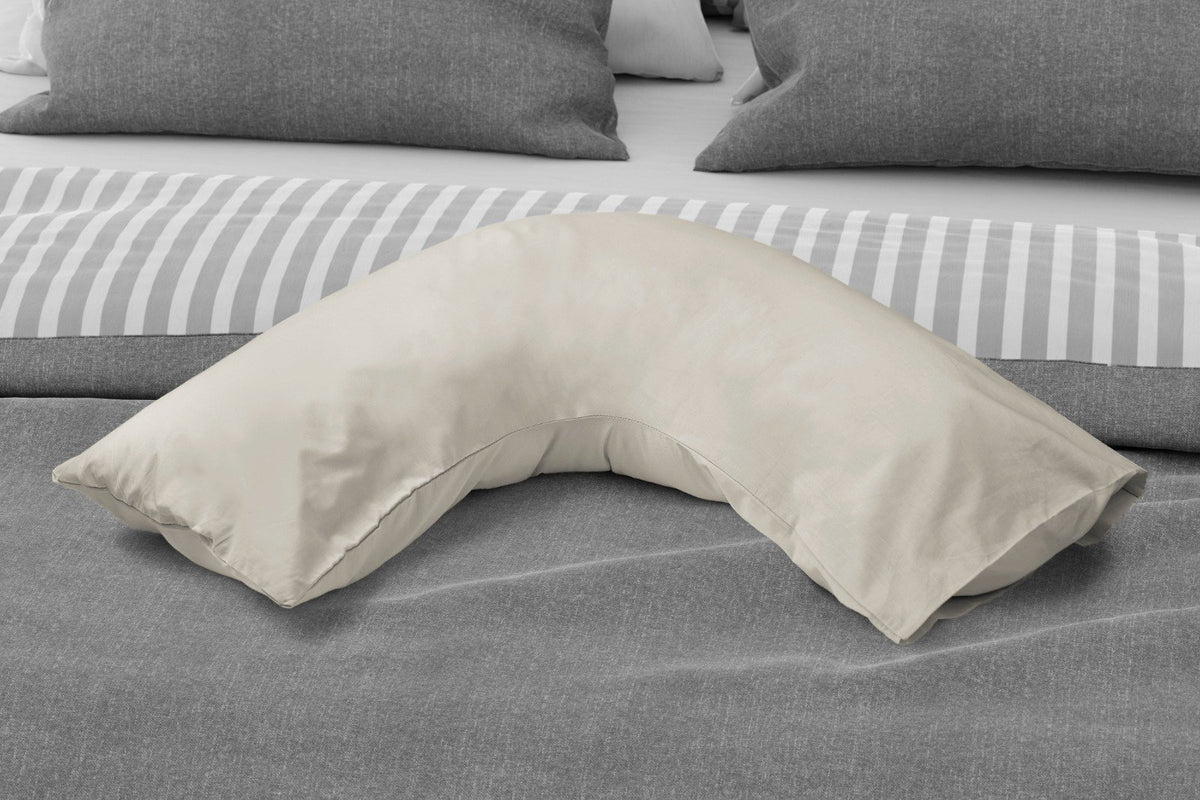 Ivory percale V-shape pillowcase styled on a bedroom support pillow