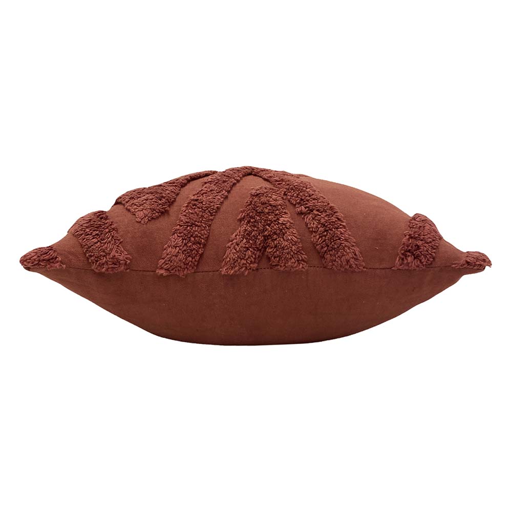 Side profile of the plump cushion showing the tufted chevron pattern along the top edge and the plain terracotta sides – Kumperi