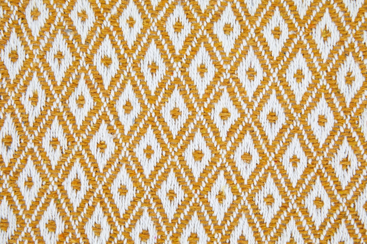 Close-up of ochre and white diamond weave fabric texture, Kumperi