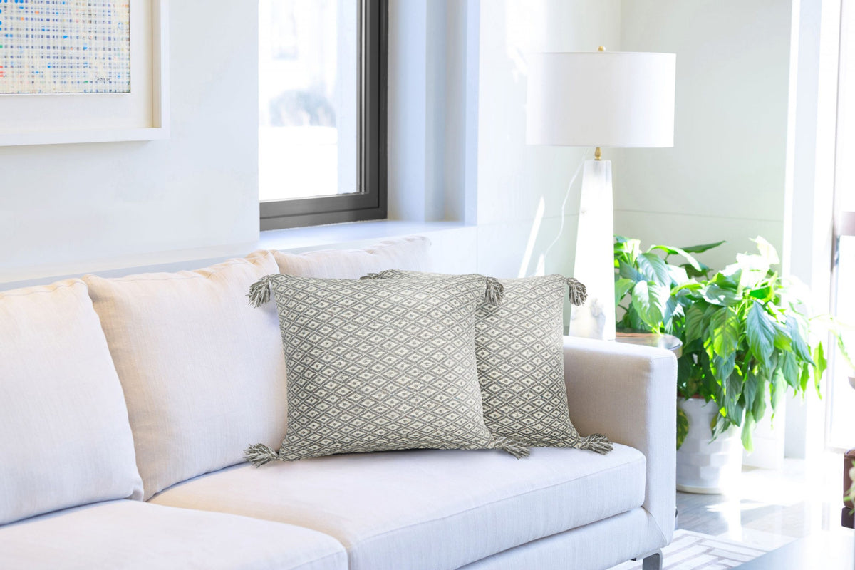Silver-grey natural diamond weave cushion covers with tassels styled on a cream sofa, Kumperi