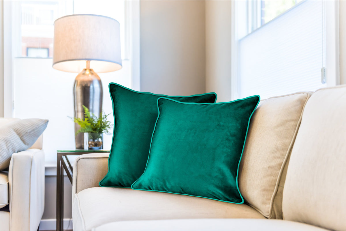 Emerald green soft touch velvet cushion covers styled on cream sofa beside table lamp, Kumperi