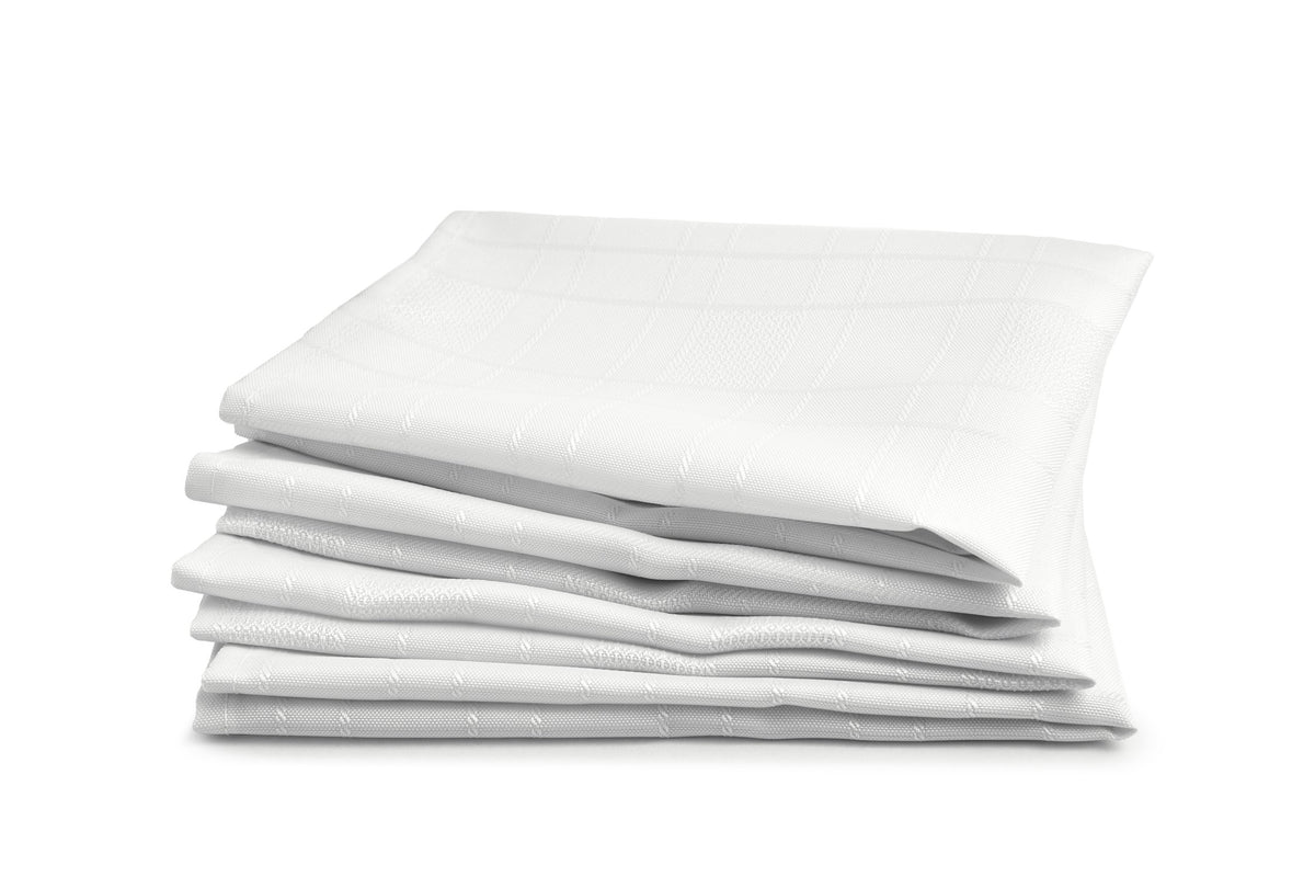 Stack of folded white chequers fabric showing woven check pattern, Kumperi