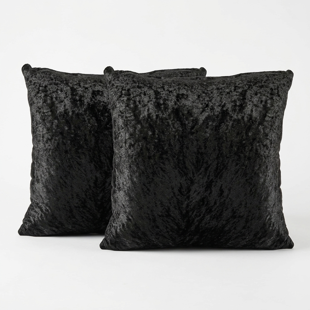Two black crushed velvet cushion covers standing upright on white background, Kumperi