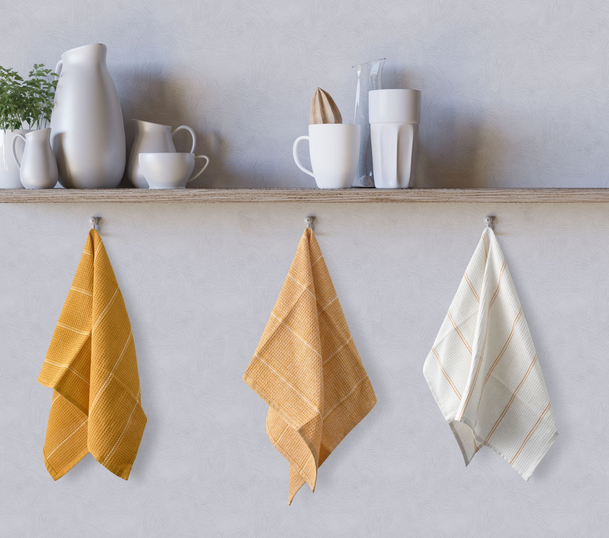 Ochre, ochre and white waffle kitchen tea towels hanging on kitchen hooks below shelf, Kumperi