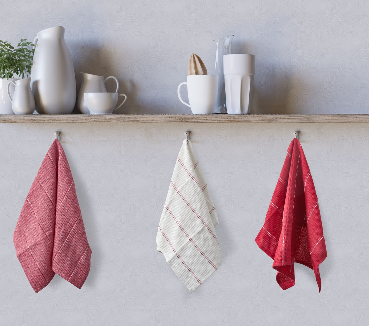 Red, white and red waffle kitchen tea towels hanging on kitchen hooks below shelf, Kumperi