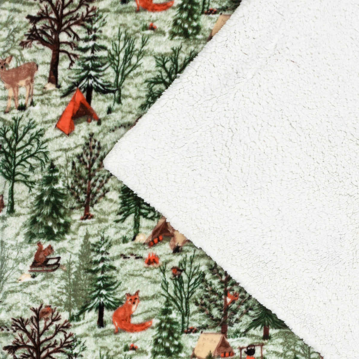 Corner of the throw folded back to show the printed woodland scene face with a deer, fox and pine trees alongside the plain cream sherpa fleece reverse – Kumperi