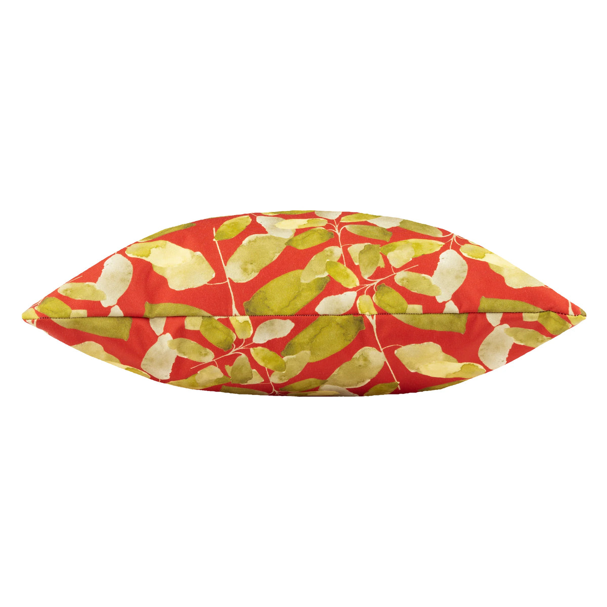 Side-on profile view of the plump, fibre-filled cushion showing the leaf print wrapping around the piped edge – Kumperi