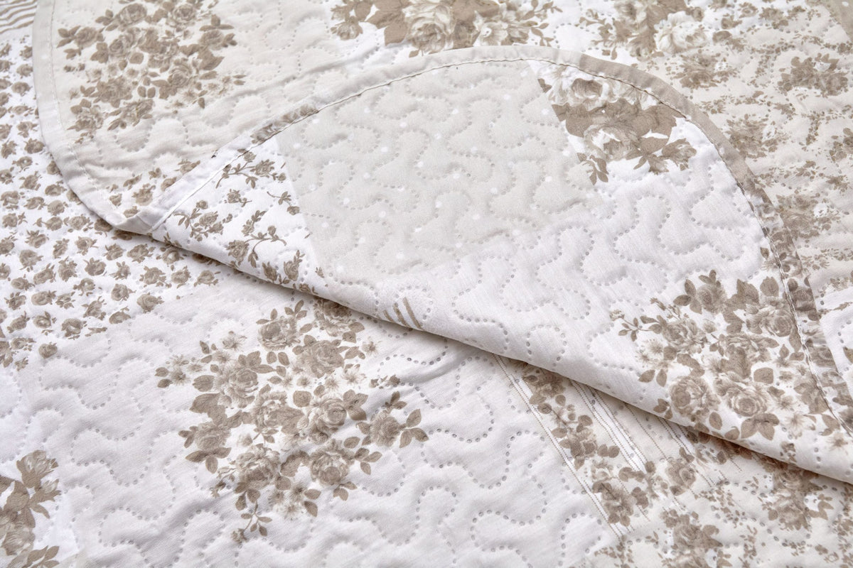 Close up of natural quilted patchwork floral fabric texture with scalloped edge detail