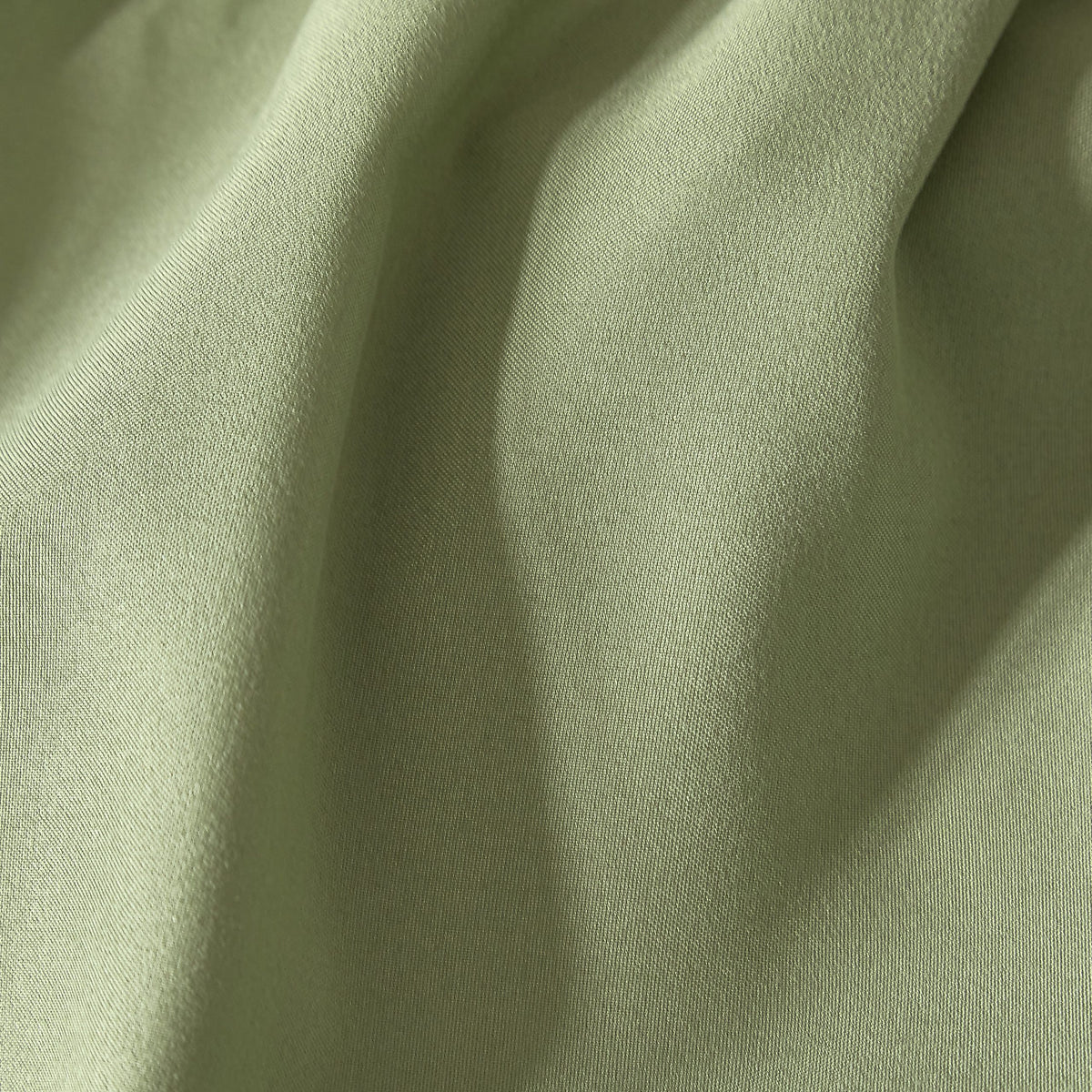 Close-up of olive soft touch 100% polyester fabric texture non-iron easy care double fitted sheet