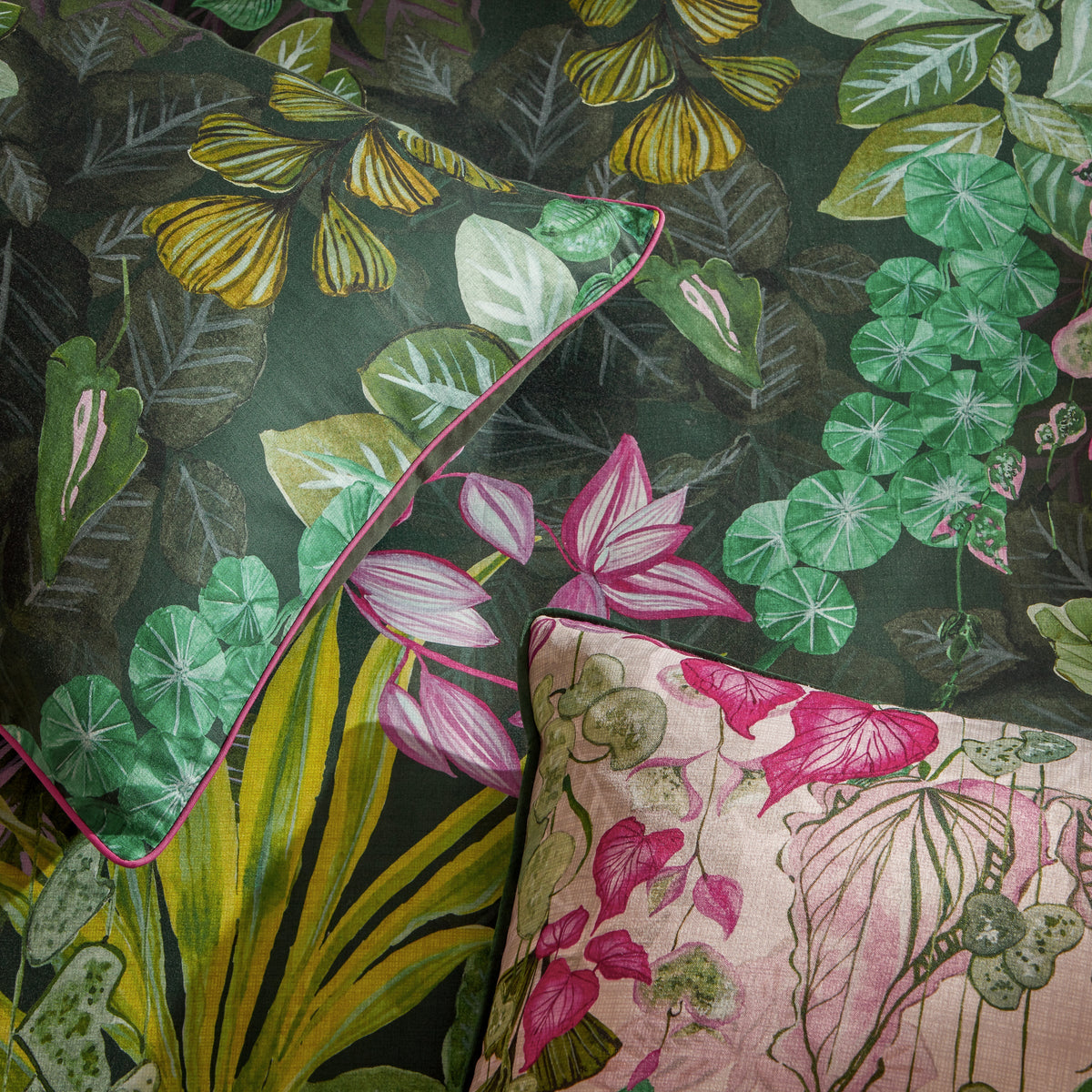 Close-up of Veadeiros floral print fabric detail with pink piped trim edge, pink/green – Paoletti