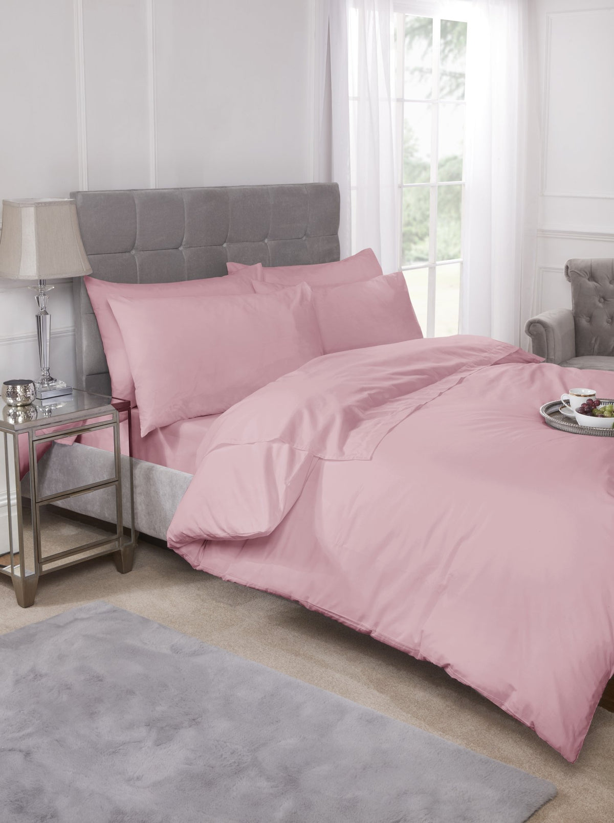 Pink percale housewife pillowcase pair styled on a neatly made bed
