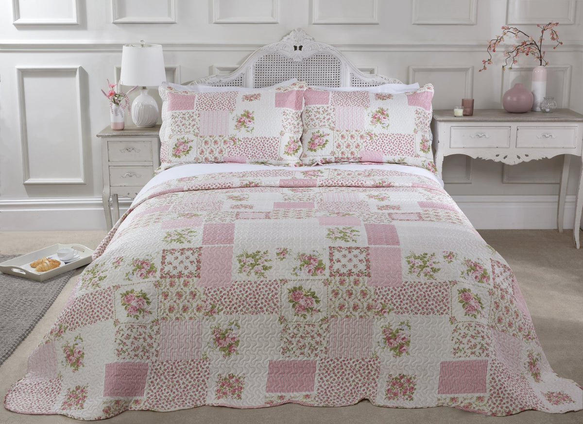 Pink quilted patchwork floral bedspread set styled on a neatly made double bed