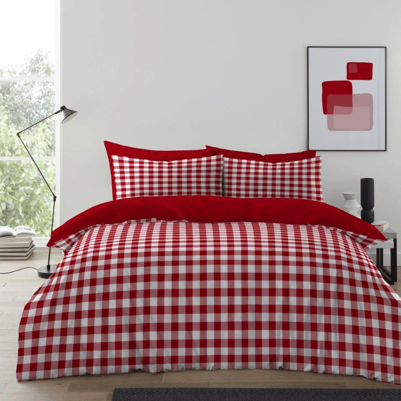 Red and white gingham check king duvet cover set reversible with solid red reverse styled on a king bed classic bedroom
