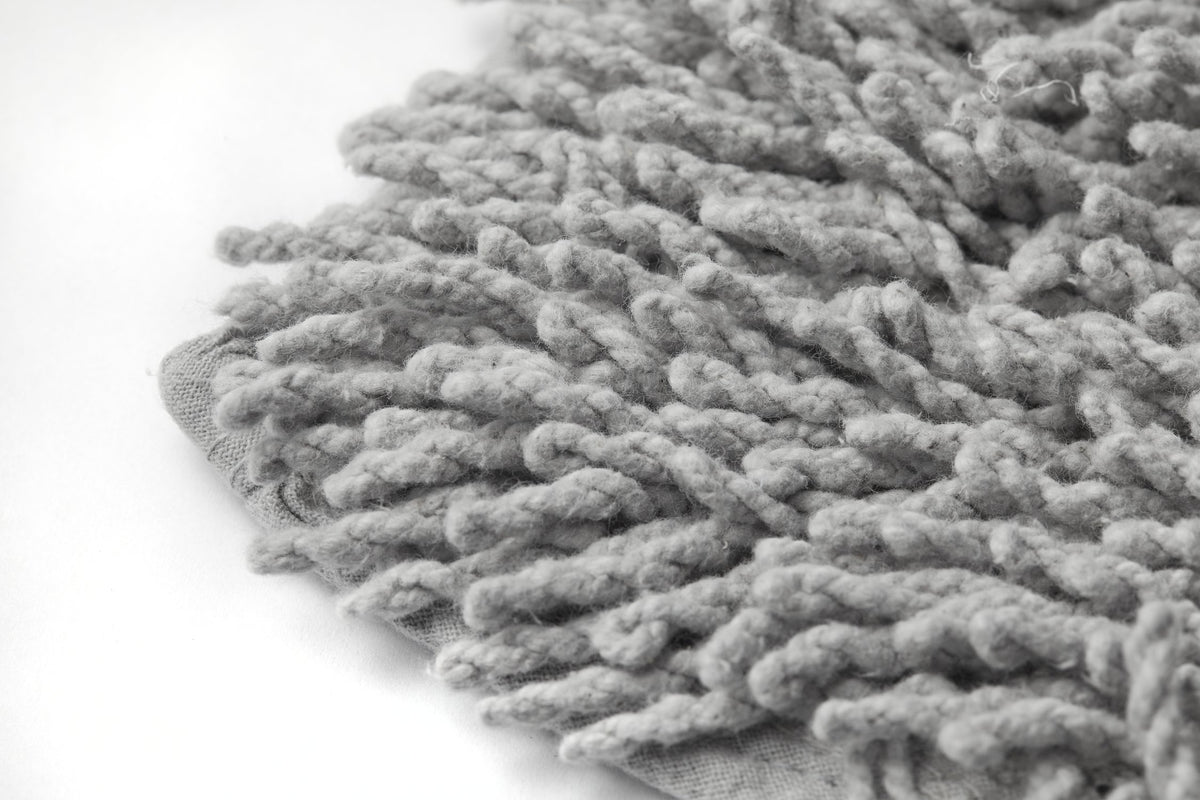 Black and white extreme macro close-up of silver cotton high pile loop twist bath mat showing thick rope-like twisted yarn loops and woven hessian backing edge luxurious soft pile depth highly absorbent natural cotton Emma Barclay Classics Collection