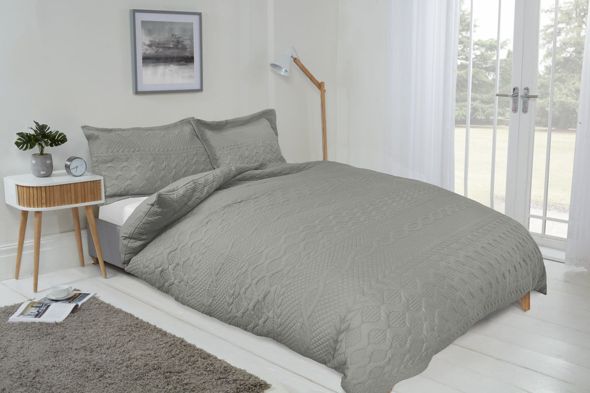 Silver luxury quilted embossed duvet cover set styled on a neatly made double bed