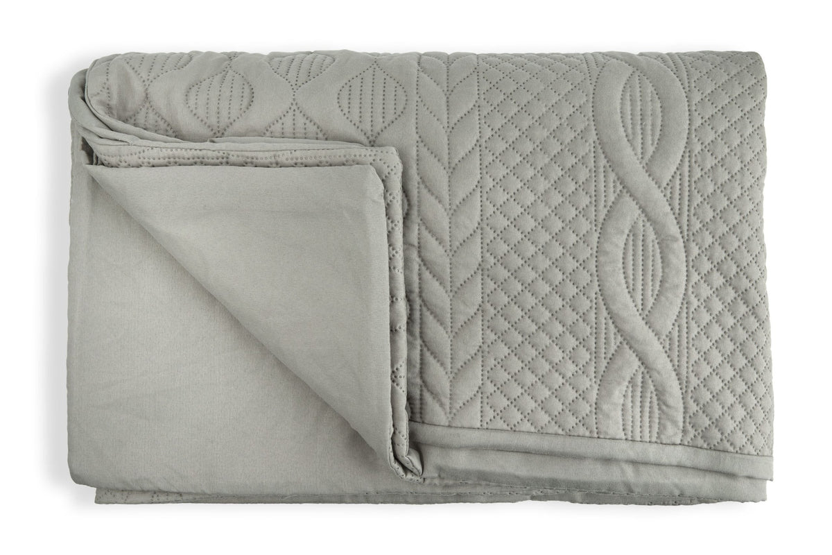 Close up of silver soft touch quilted microfibre fabric with embossed diamond and leaf pattern