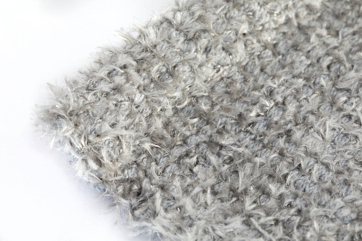 Extreme close-up of silver grey Twinkle shaggy bath mat showing soft fluffy pile with fine metallic twinkle threads catching the light Emma Barclay Lifestyle Collection
