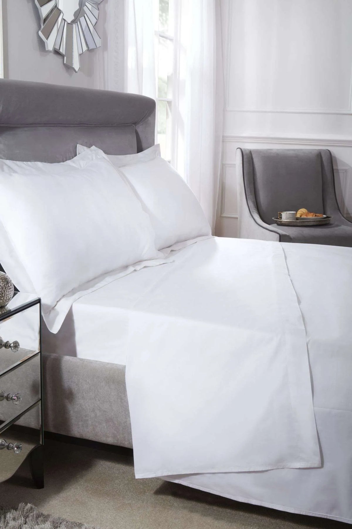 White 400-thread-count Oxford pillowcase pair styled on a neatly made luxury bed