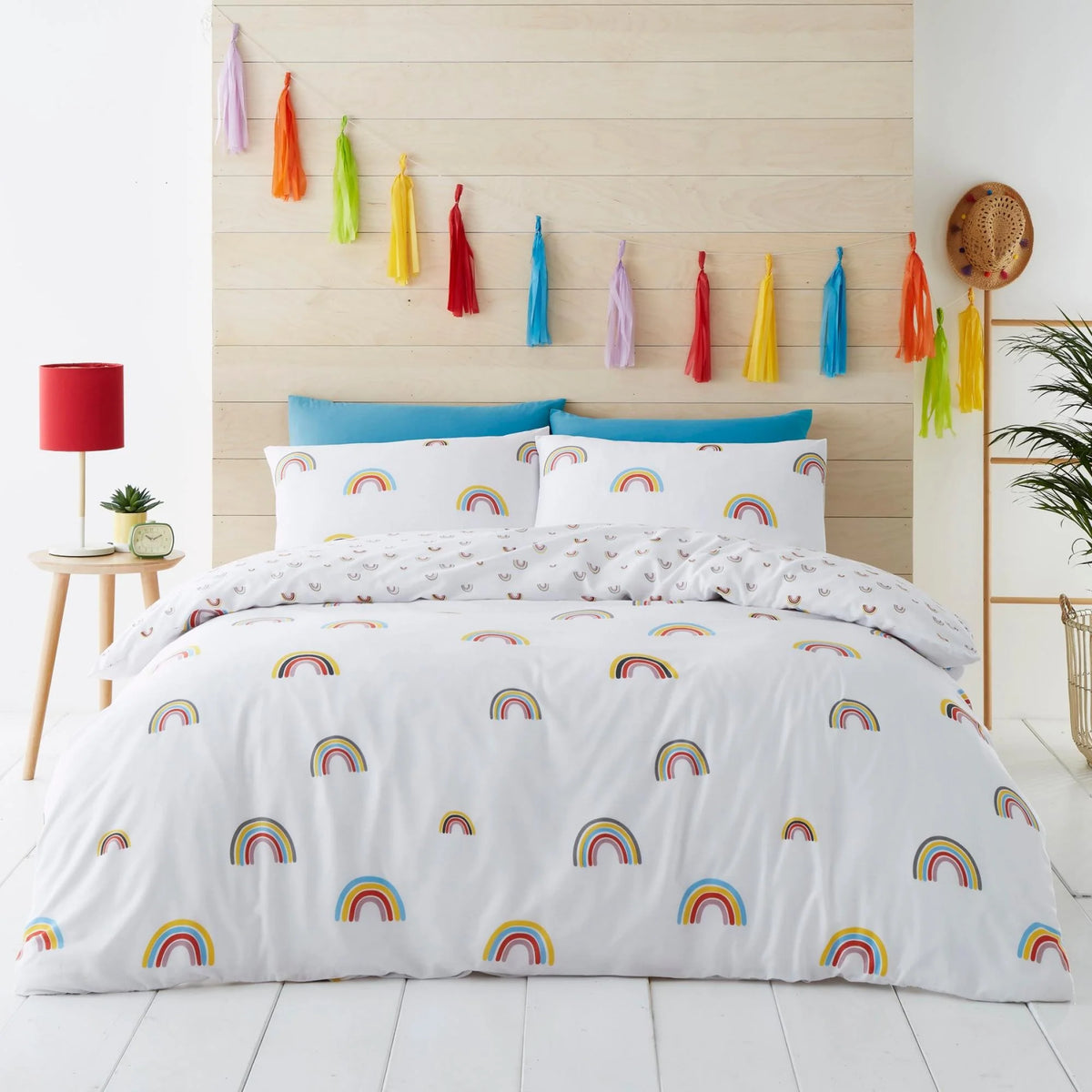 White king duvet cover set with scattered multicolour rainbow arch print styled on a king bed, cheerful bright bedroom