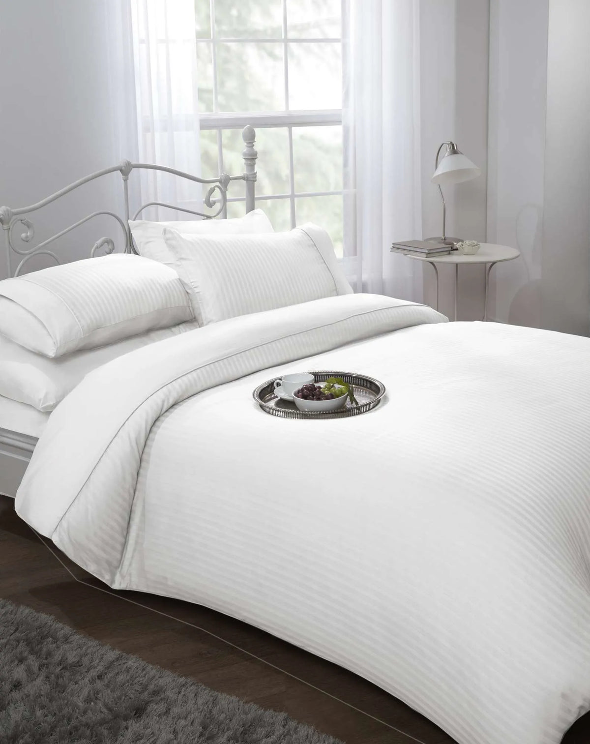 White 300 thread count sateen stripe king duvet cover set styled on a luxury hotel style bed